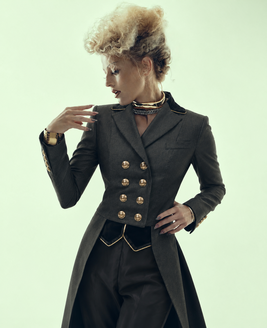Editorial portrait of a rider in a charcoal double-breasted dressage tailcoat with gold buttons and crystal choker