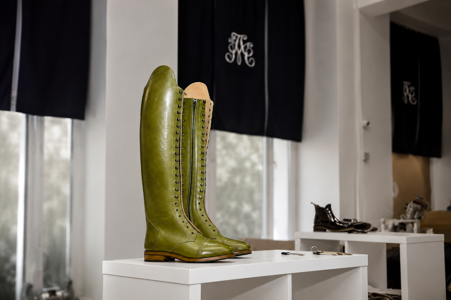 Alexandre Mason atelier interior with a bespoke olive green riding boot on display